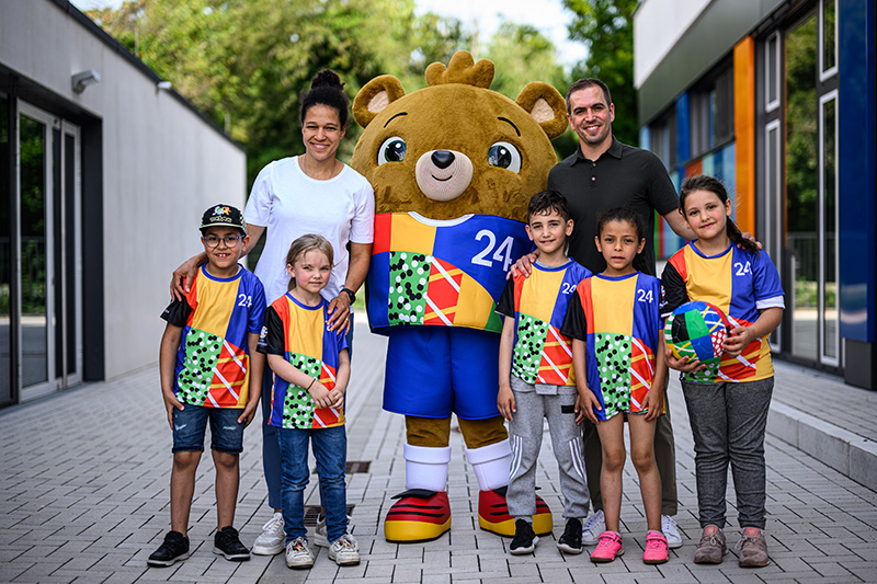 EK 2024 mascotte in een groepsfoto met kinderen